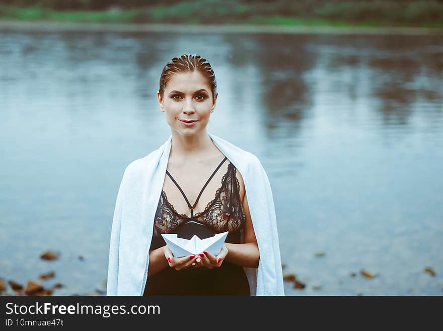 girl holding a paper boat