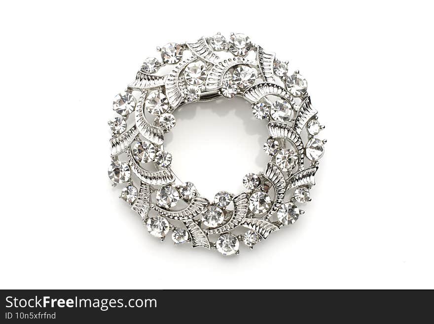 round brooch with diamonds isolated on white.