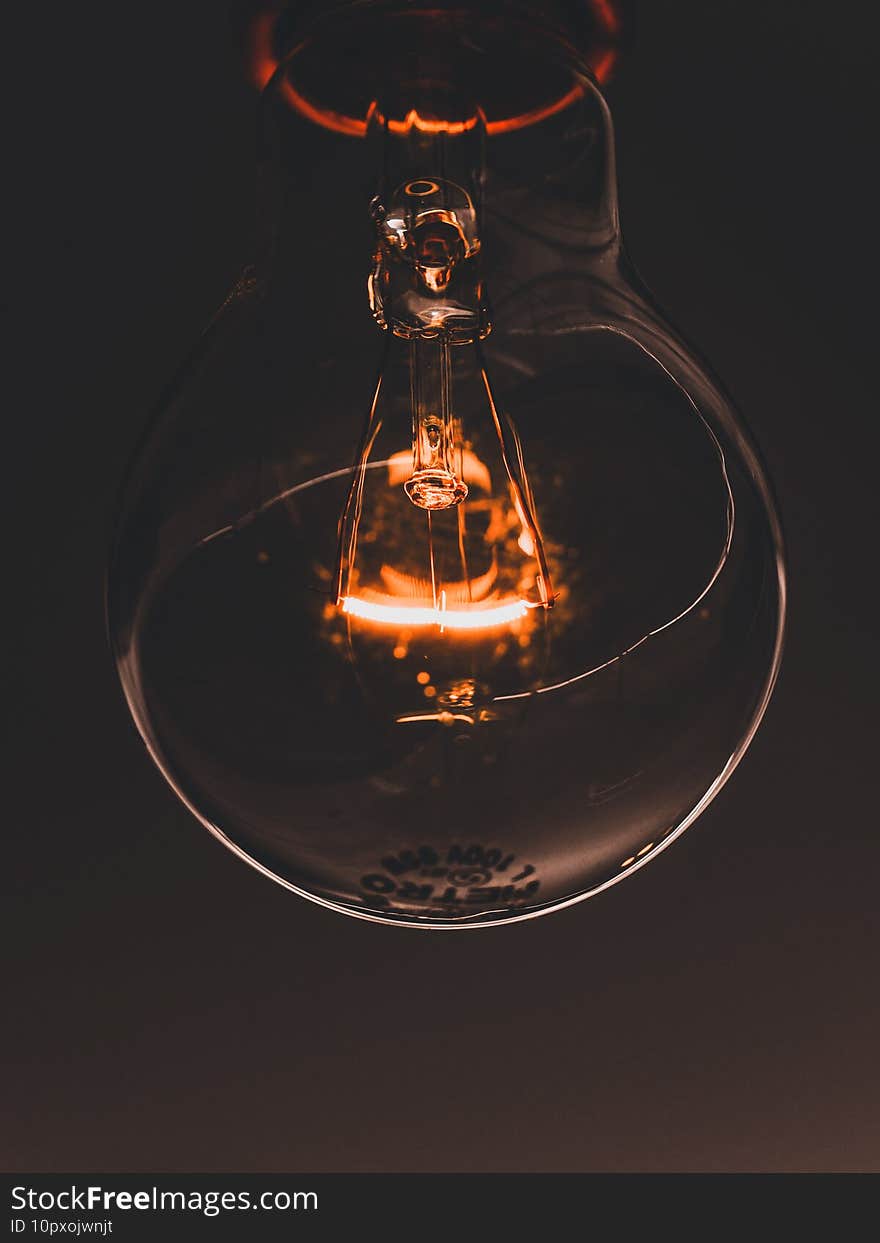 Closeup shot of a lighted incandescent lamp in the darkness