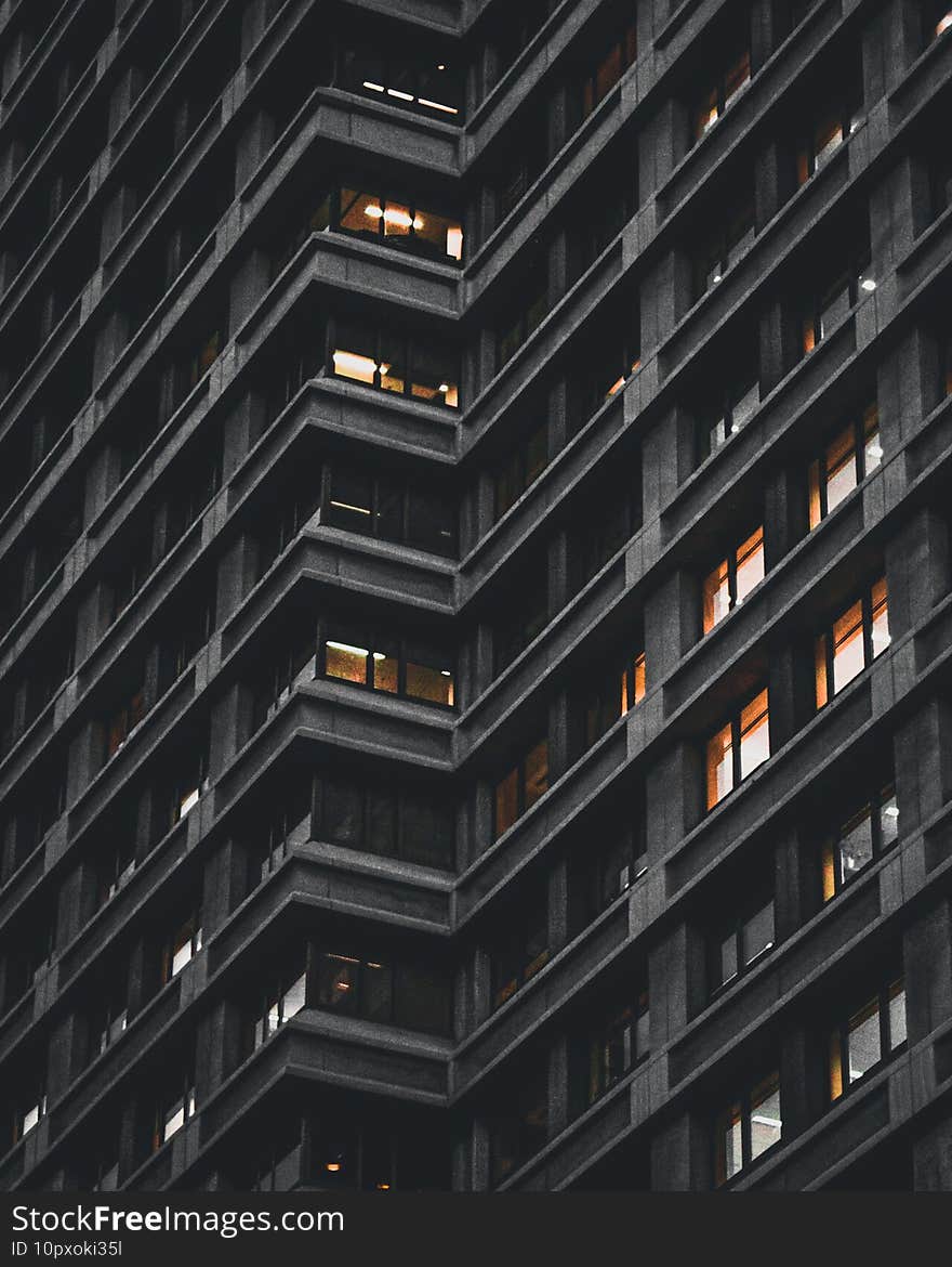 Low angle shot of a skyscraper building during the nighttime