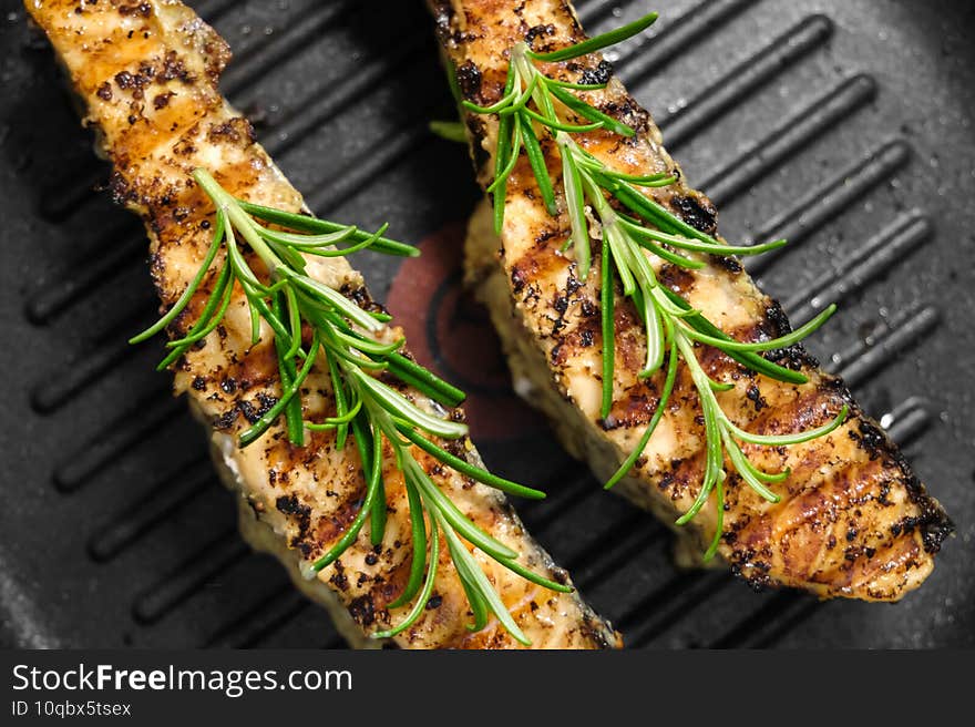 Roasted salmon fish fillet with rosemary on a grill pen. Homemade healthy dinner