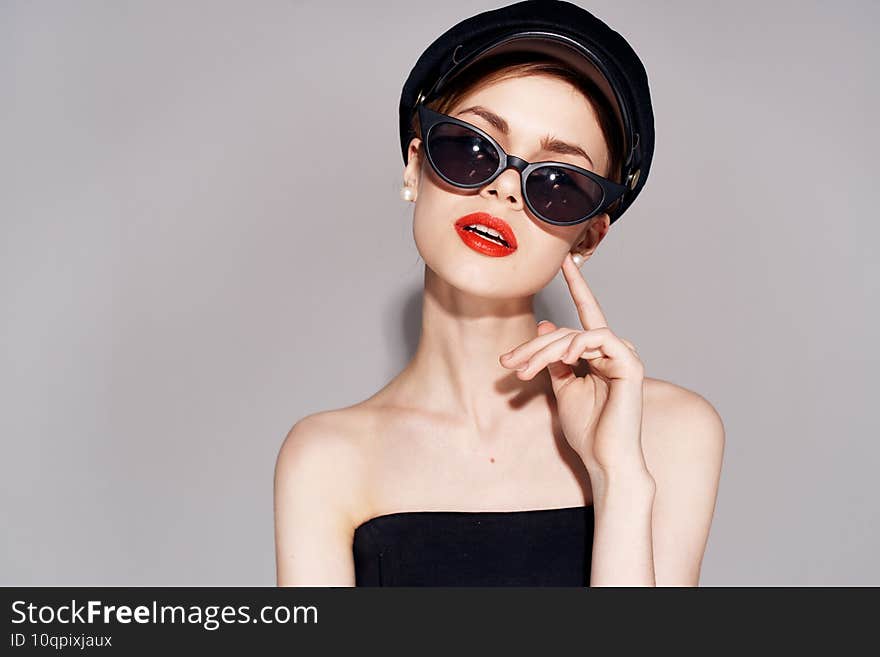 Pretty woman fashionable clothes dark glasses red lips evening dress