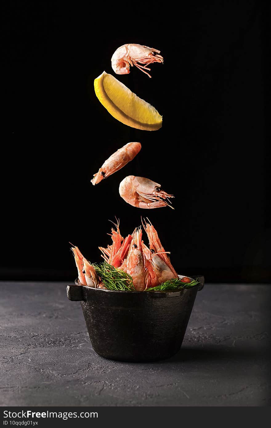 Grilled shrimps . Seafood, shelfish. Shrimps Prawns with spices and fresh herbs on stone black background