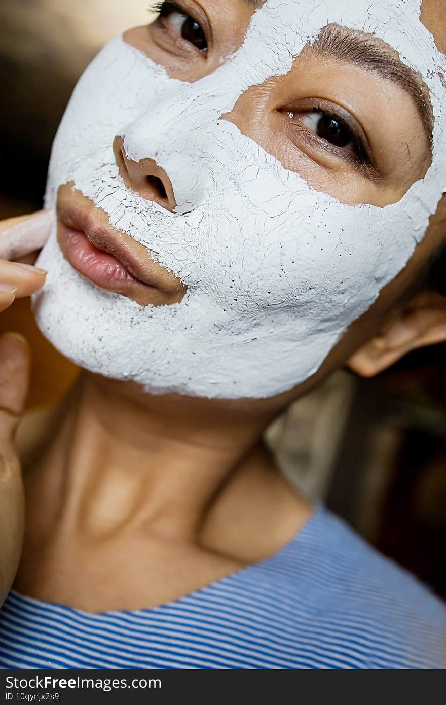 Happy Young Asian Woman Applying Clay Mask On Her Face At Home, Close-up.