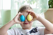 Portrait Of A Cute Child With Easter Eggs. Easter Lunch. The Feast Of Holy Easter Royalty Free Stock Image