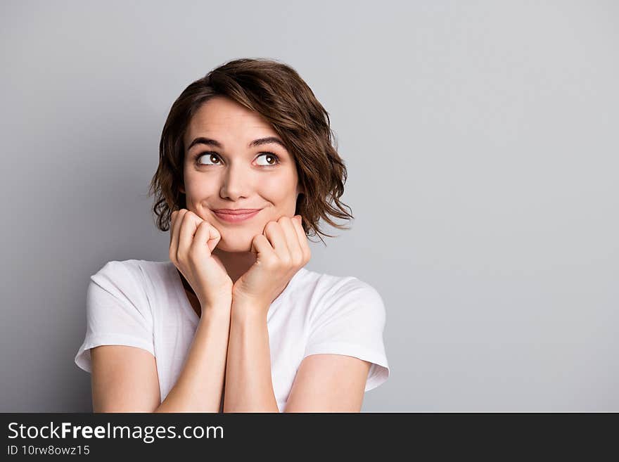 Photo of young cute girl wear casual outfit hands touch cheeks look empty space isolated over grey color background