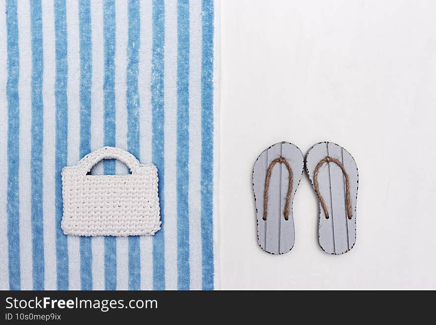 Concept of beach holiday. Beach flip-flops, knitted beach bag. Summer flat lay. Copy space