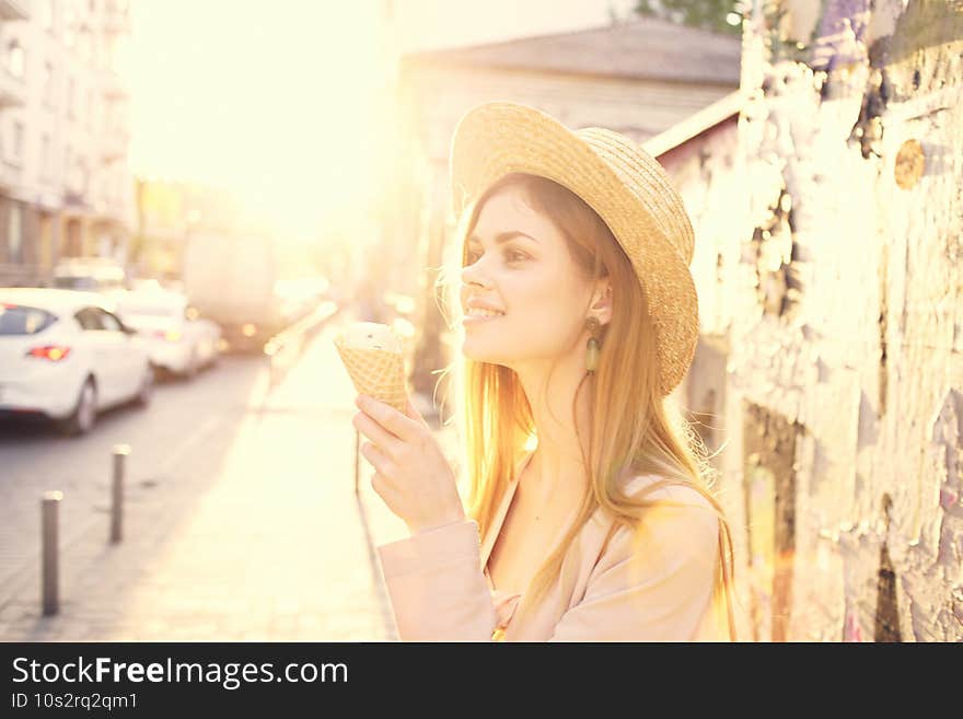 Cheerful woman in hat eating ice cream walk outdoor sun