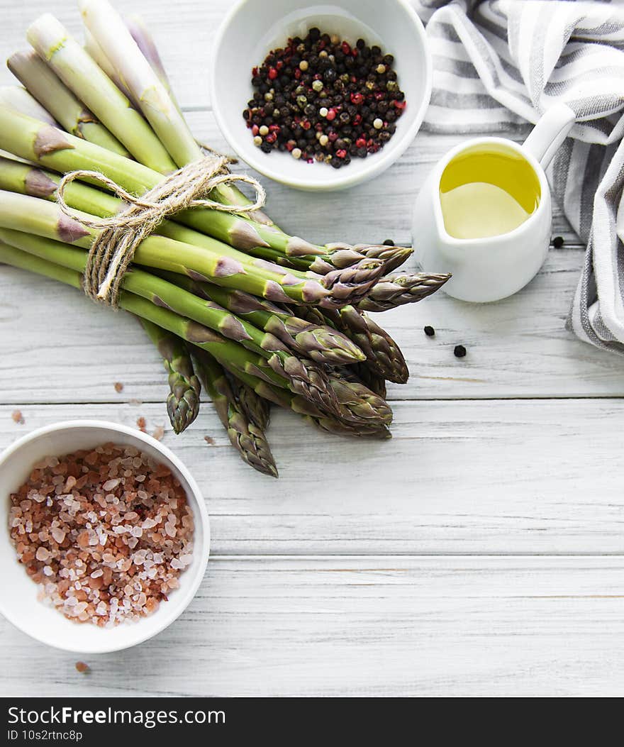 Bunch of raw asparagus stems with different spices