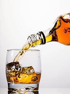 Pouring Whisky From A Bottle Stock Image