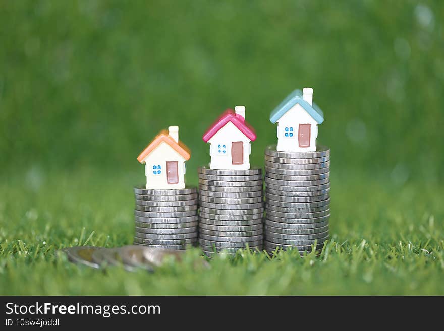 Finance, Model house on Stack of coins money on natural green background, Business investment and real estate