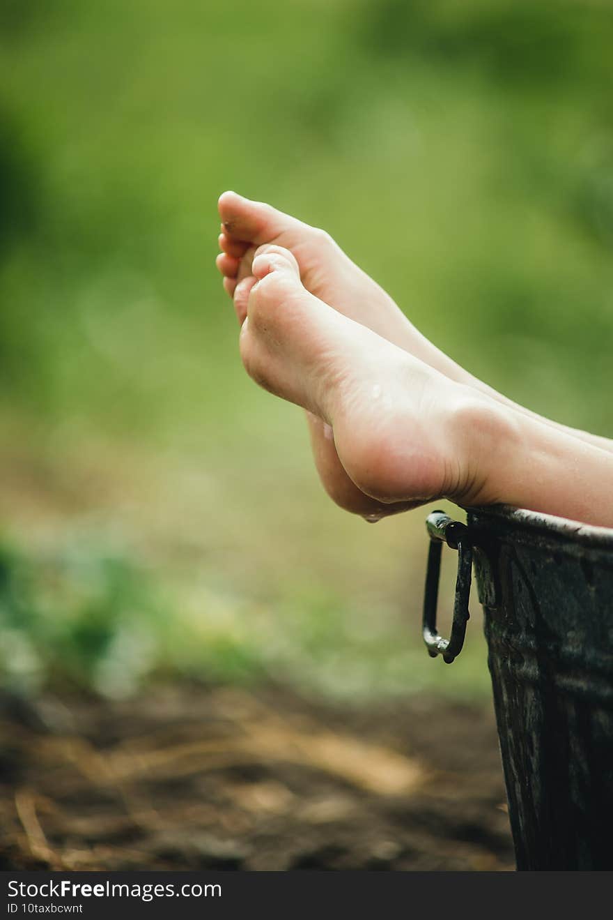 Barefoot baby feet on a green background close-up. Barefoot baby feet on a green background close-up