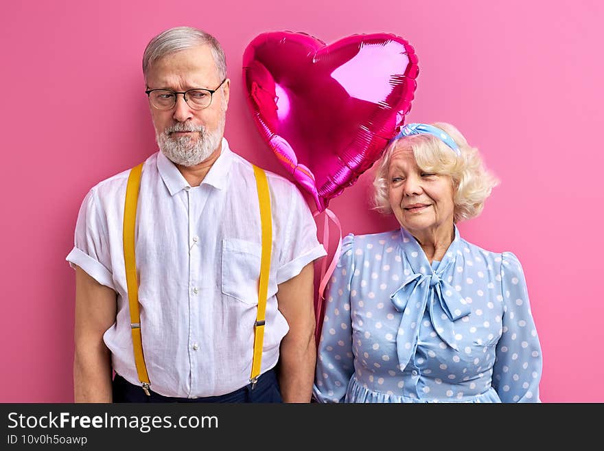 sad men and happy mature women with ait ballon, celebrating saint valentines day  on pink background. sad men and happy mature women with ait ballon, celebrating saint valentines day  on pink background