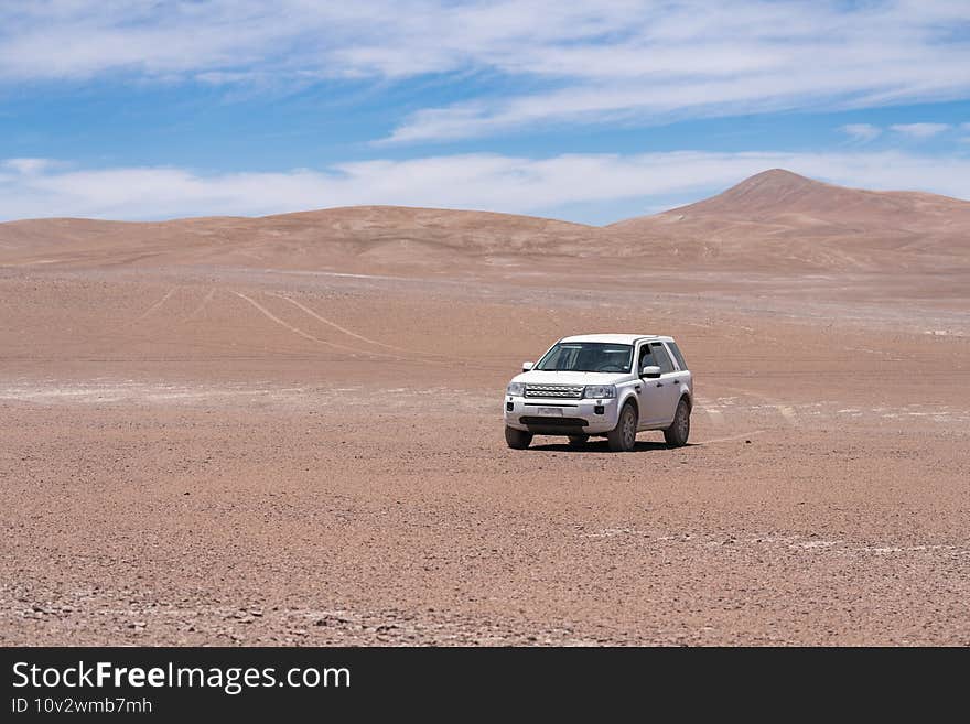 Exploring Atacama Desert vast dry extensions in the driest area of this amazing desert with an all terrain vehicle. An awe road