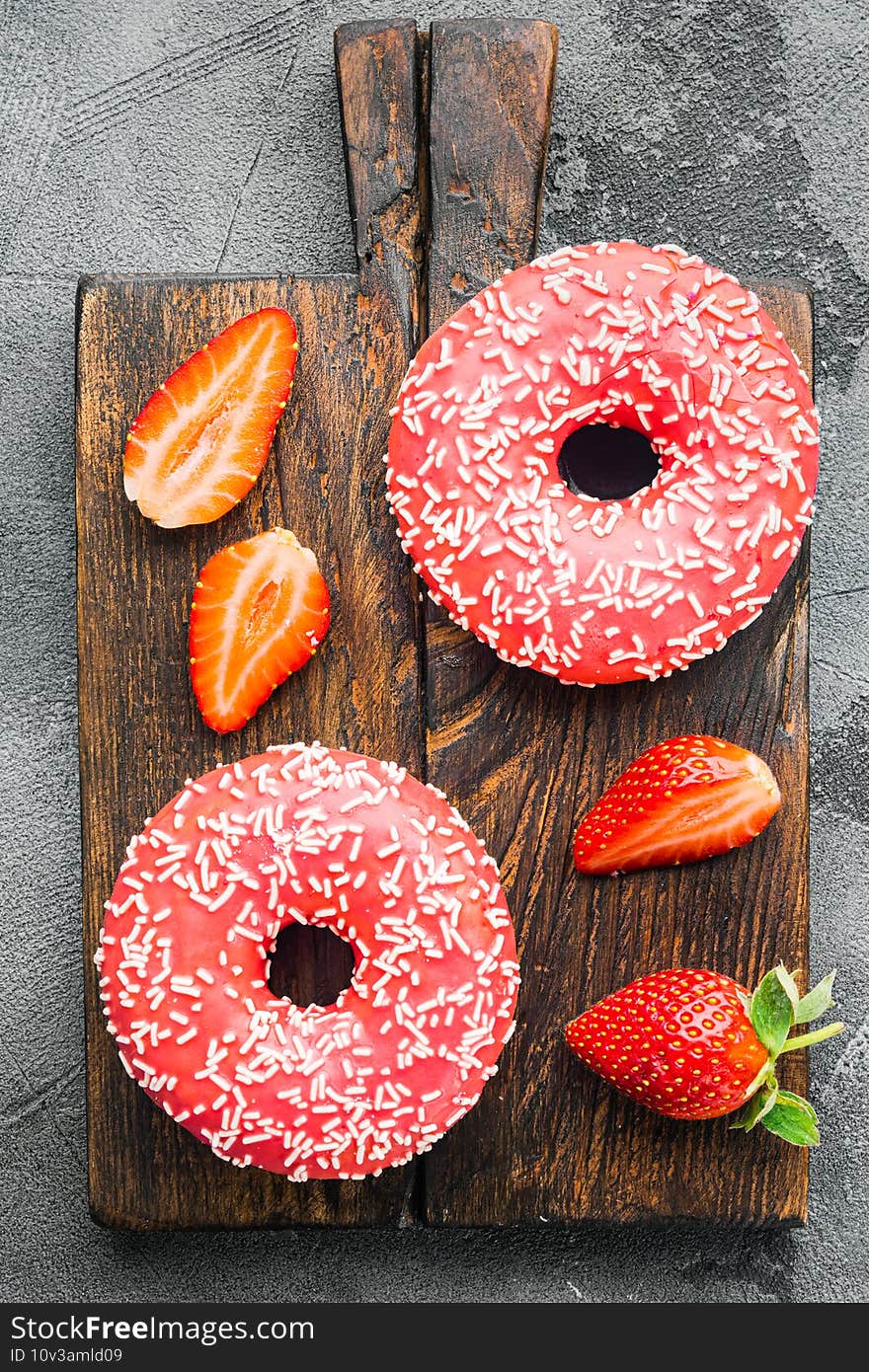 Pink donuts with crumble, on gray background