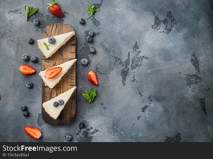 Classic New York Cheesecake sliced, on gray background, top view flat lay with copy space for text