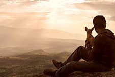 Man Spending Time Together With His Dog Pet In Nature In Top Of Hill. Rhodope Mountains Bulgaria. Background, Copy Space Stock Photo