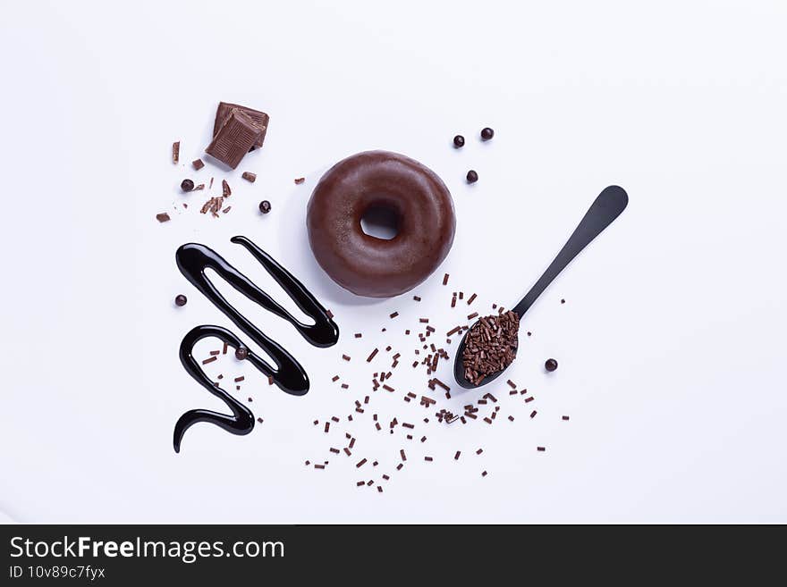 Chocolate donut and chocolate on white background. Top view