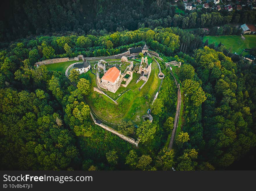 The extensive ruins of Potstejn Castle lie on a wooded conical hill southeast of the village of Potstejn in Eastern Bohemia and dominate the central part of Podorlicko. The extensive ruins of Potstejn Castle lie on a wooded conical hill southeast of the village of Potstejn in Eastern Bohemia and dominate the central part of Podorlicko.