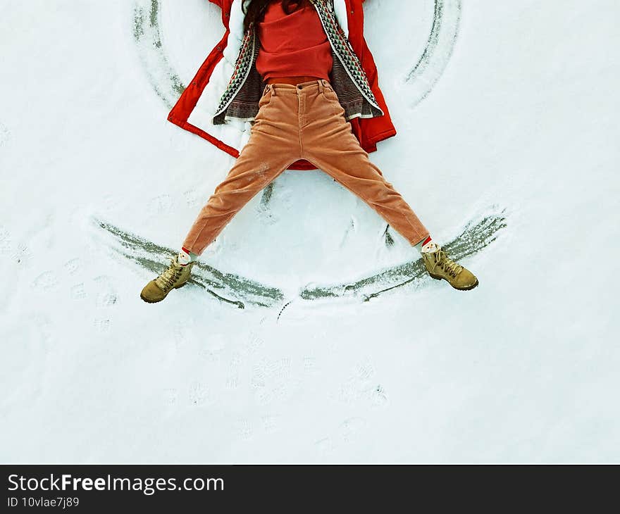 Woman Making Snow Angel. Kids Winter Outdoor Fun.