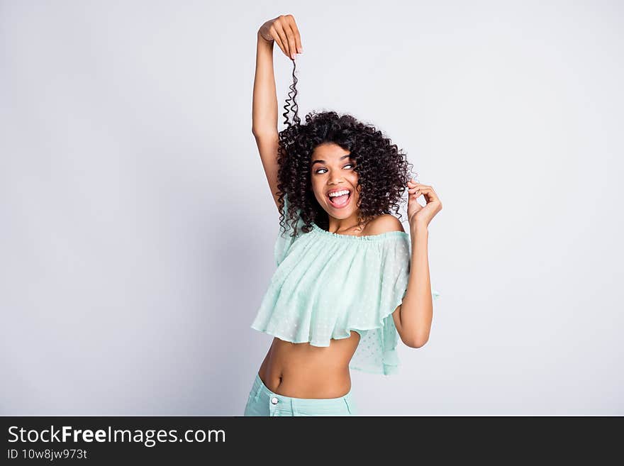 Photo portrait of funny girl lifting one hair lock with hand isolated on white colored background