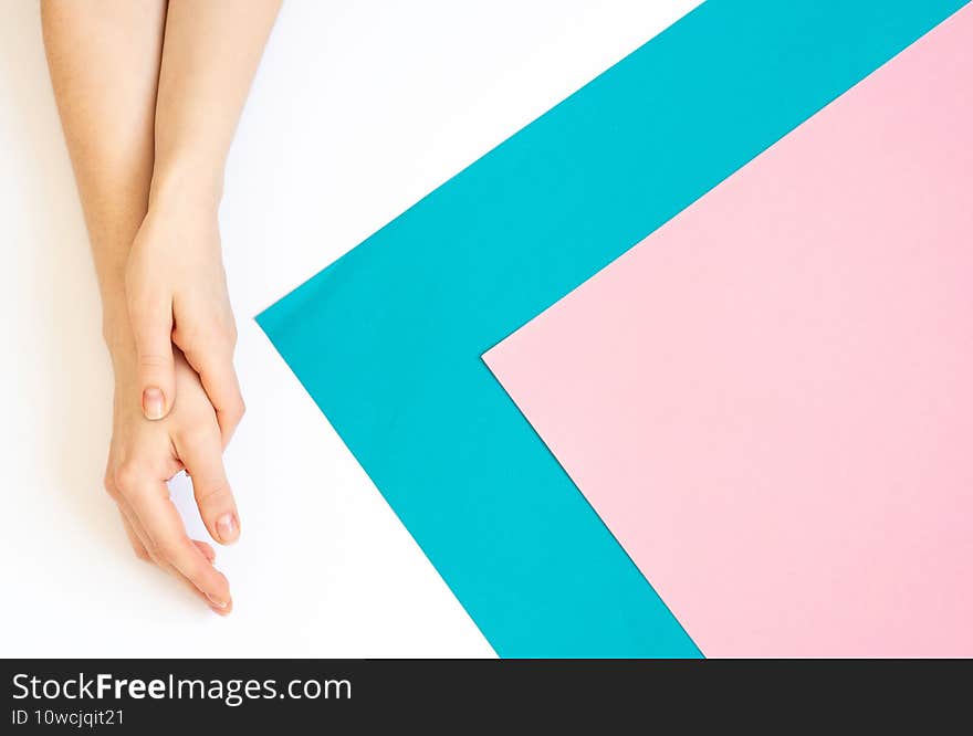 Stylish trendy female manicure. Close Up Of Female Hands. Close-up of womans hand with nature manicure on white, blue and pink