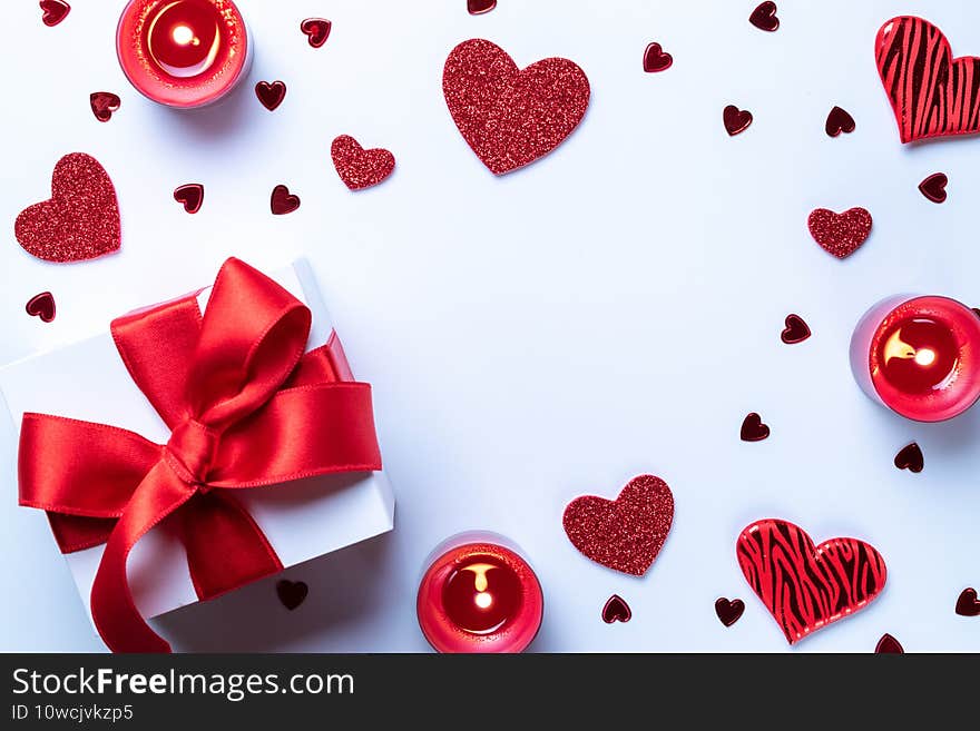 Valentines day gift box, red love hearts, romantic candle on white background. Romantic message template with copy space. Top View