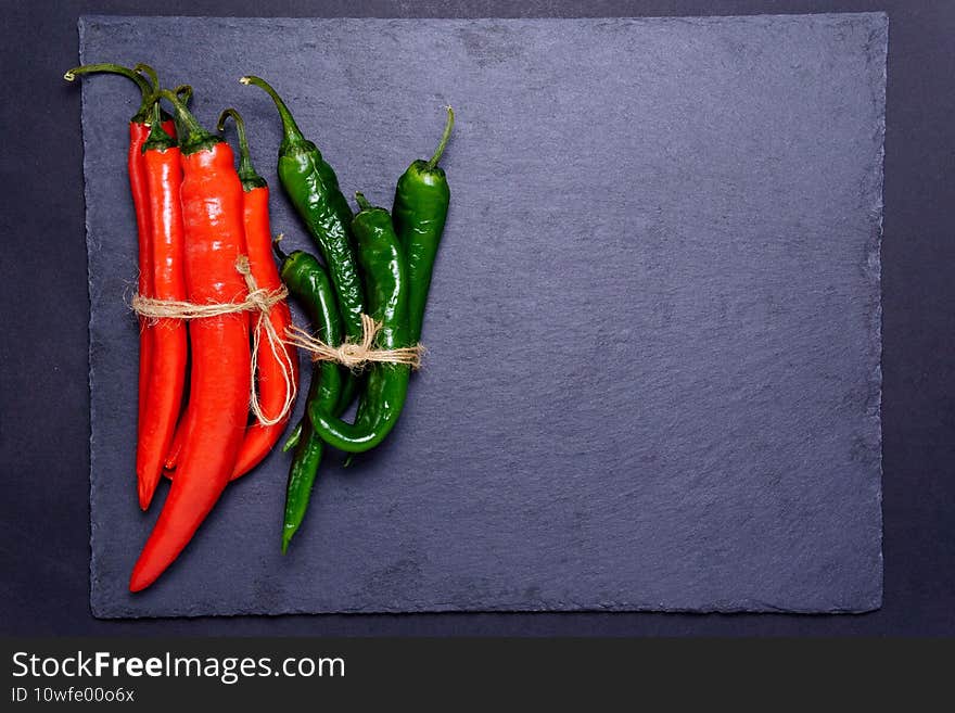 Red green pepper on black background. Food concept. Top view. Vegetable menu