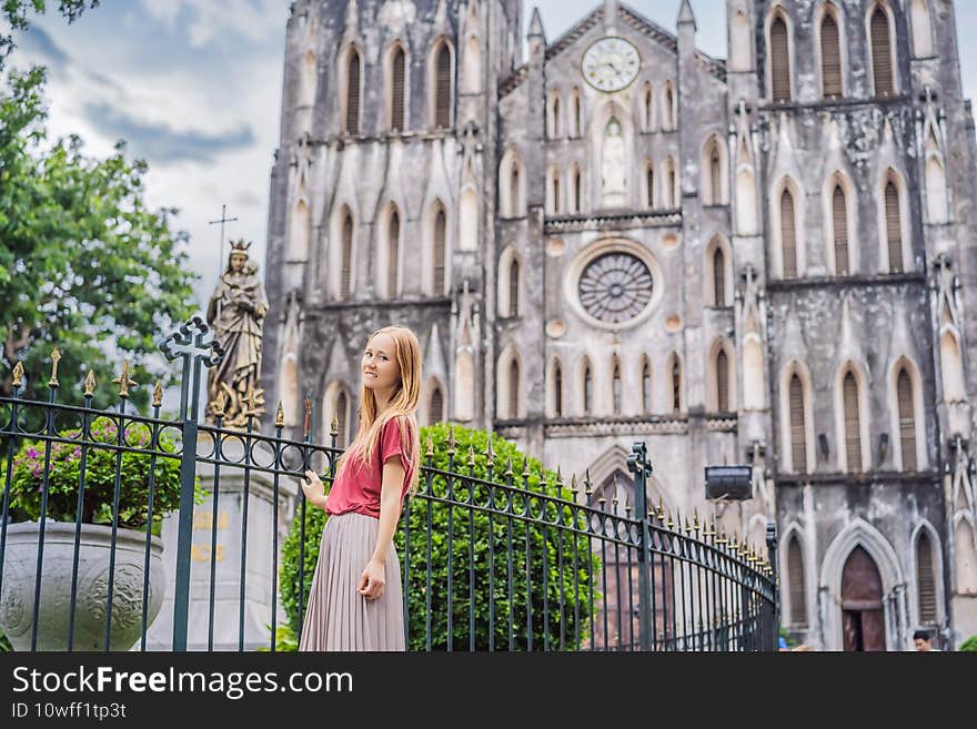 Young woman tourist on background of St Joseph& x27;s Cathedral in Hanoi. Vietnam reopens after coronavirus quarantine COVID