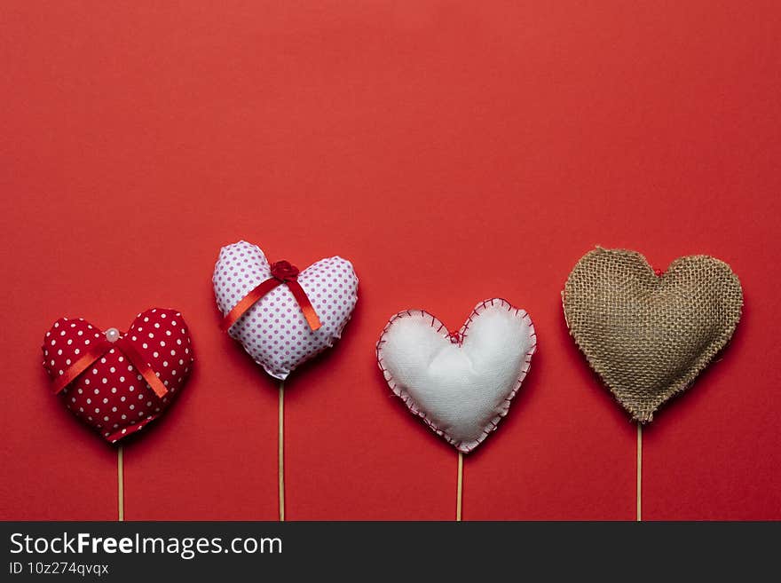 Red textile hearts on wooden sticks for Valentines day background