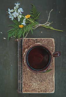 Cup Of Coffee With Old Vintage Book On The Table Stock Image