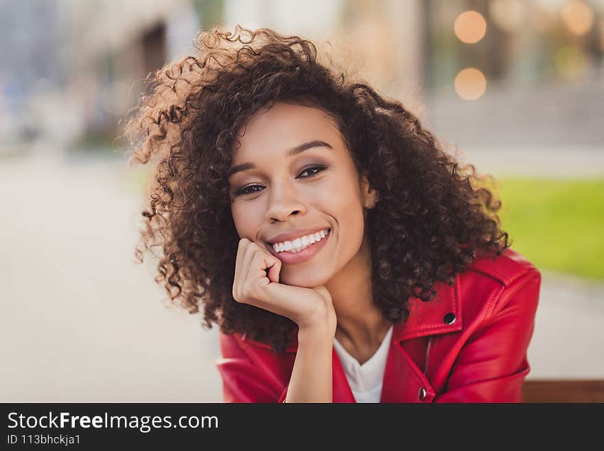 Photo of charming sweet wavy lady wear red jacket smiling hand arm chin outside urban city street