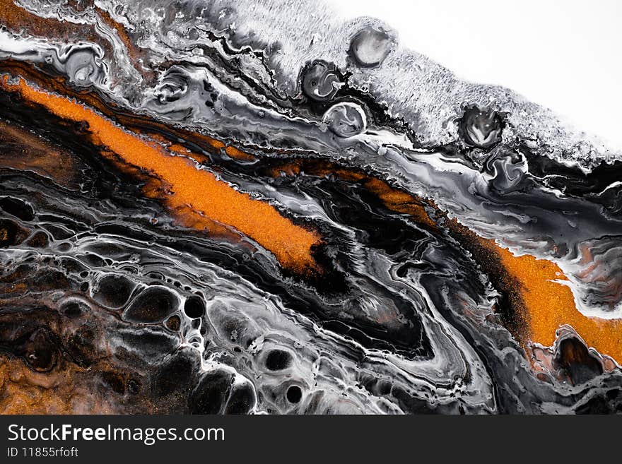 Fluid art texture. Abstract background with iridescent paint effect. Liquid acrylic artwork with flows and splashes. Mixed paints for baner or wallpaper. Black, golden and white overflowing colors