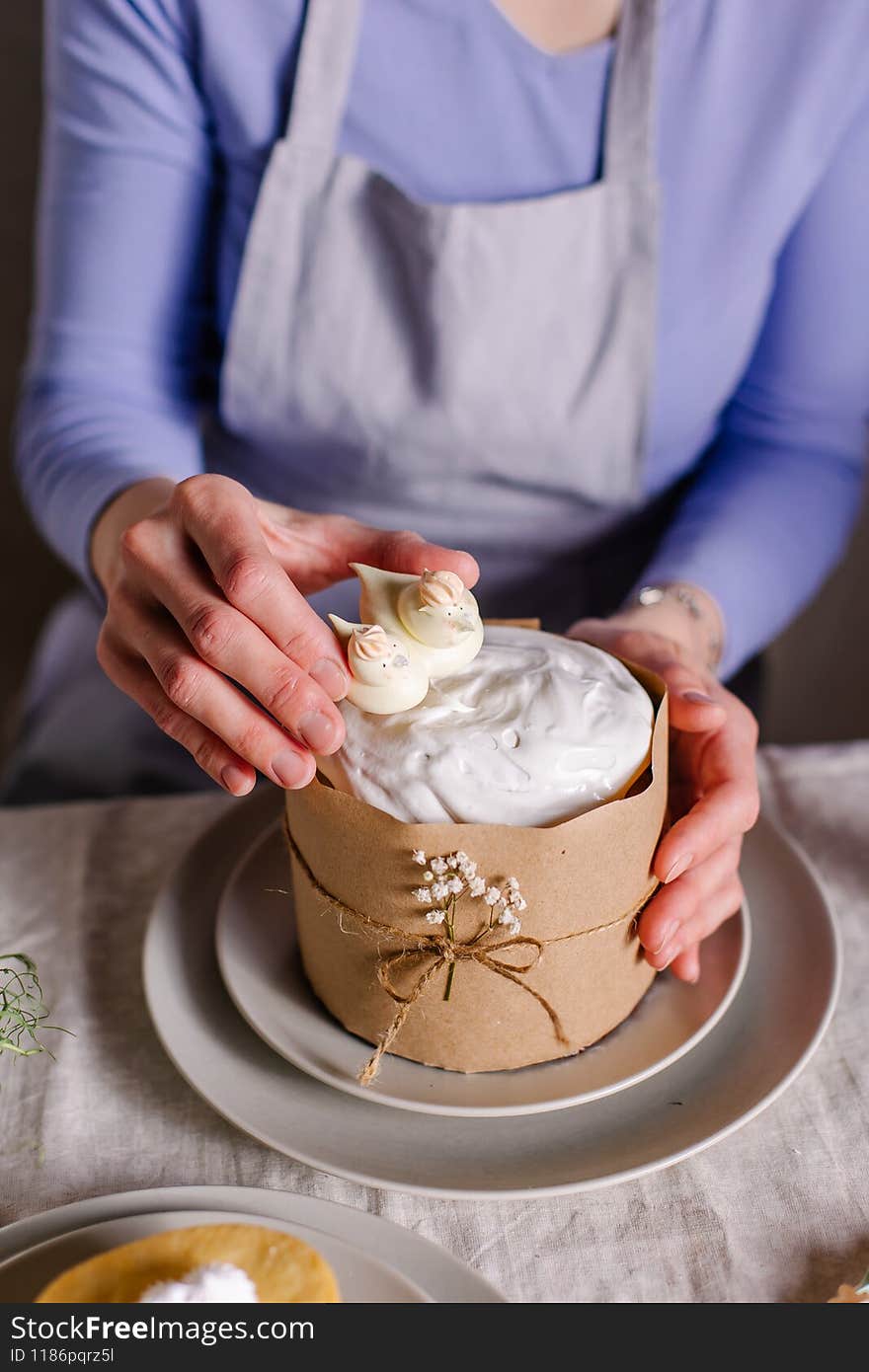 The process of decorating an Easter cake with culinary sprinkles and marshmallows. Cupcake close-up on served table. A festive treat is a Christian spring tradition. Christ is Risen. work confectioner