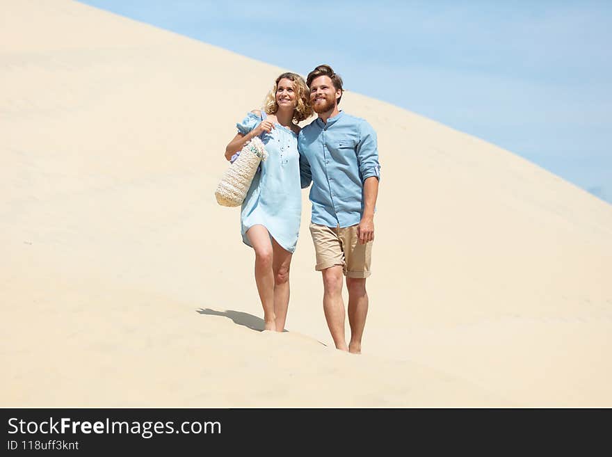 a romantic couple on a sand dune