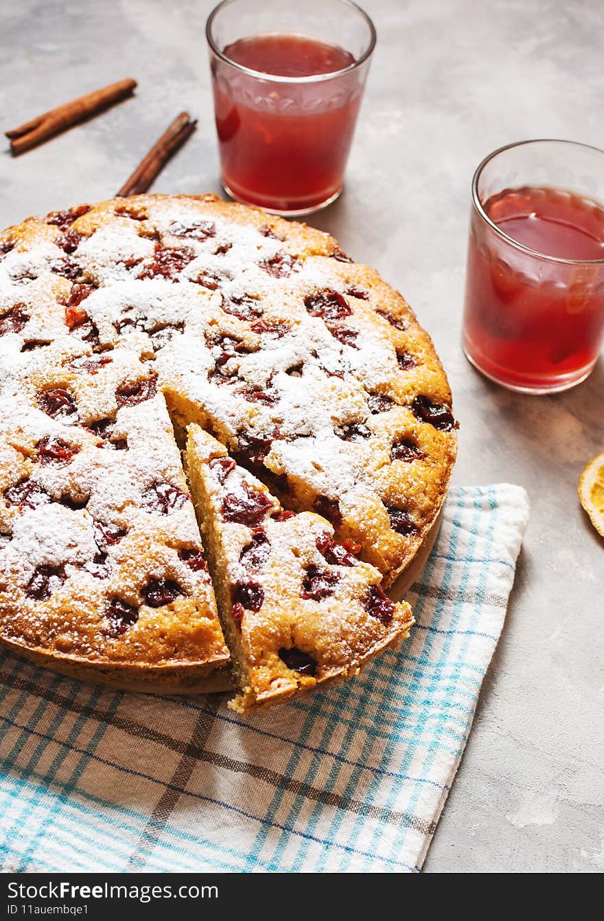 Delicious Homemade Cherry Pie and cup of compote, kissel on concrete background. Close up.