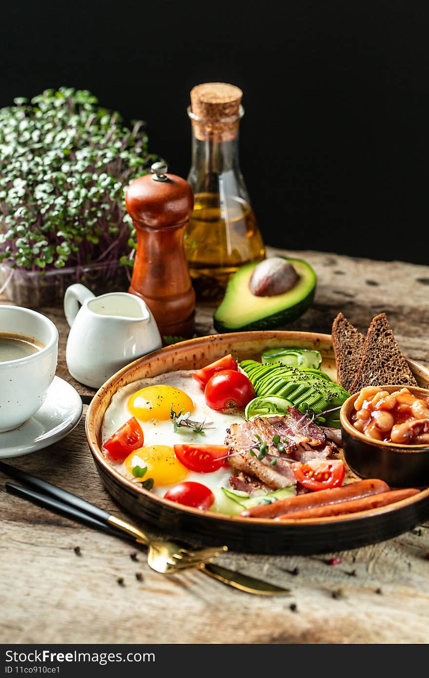 English breakfast with sausage, eggs and beans, Delicious breakfast or snack, Food recipe background. Close up, place for text.