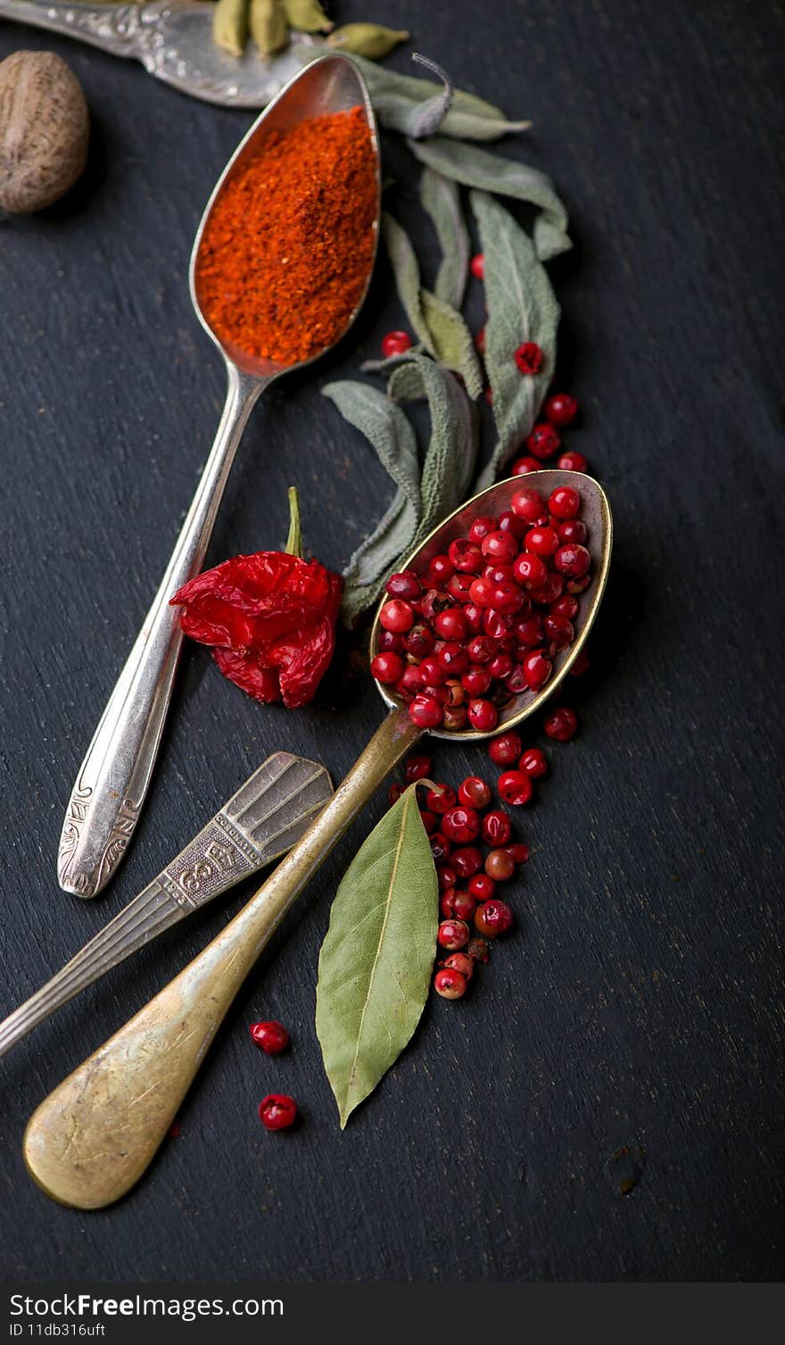 Various spices spoons on black table. Top view with copy space