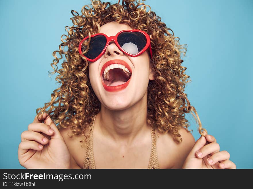 Cheerful woman Tilt your head back bright evening makeup red lips blue isolated background