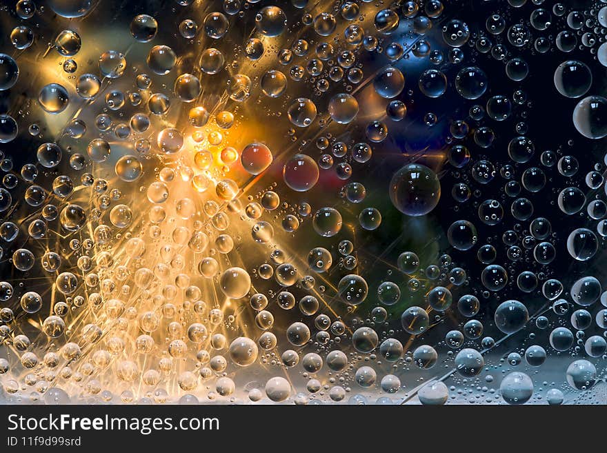 Multicolored spheres are illuminated by flashes of light and are located against a black background with blue and green balls. Space abstraction. 3D render.