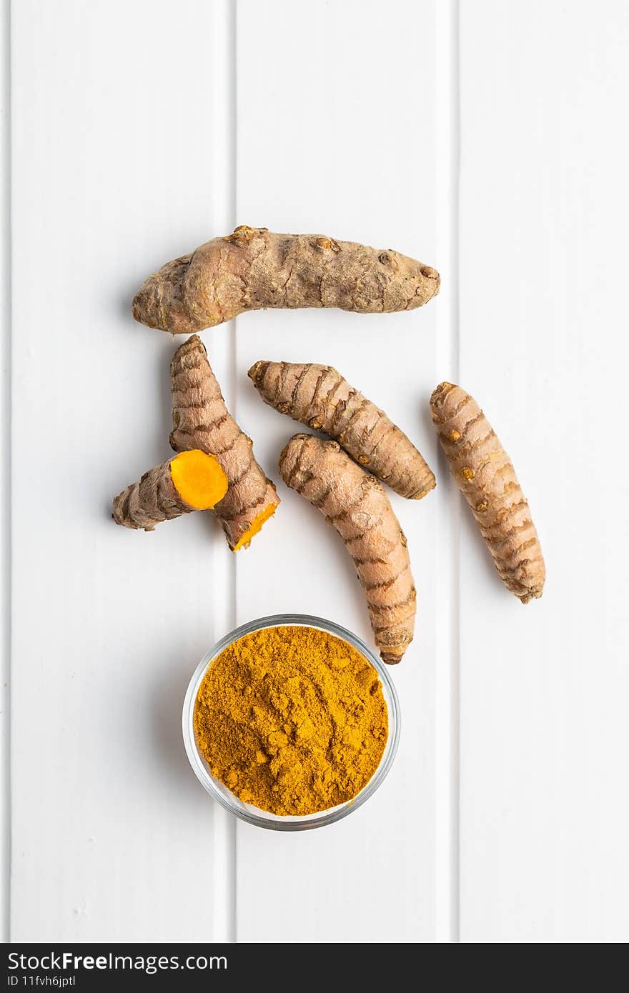 Indian turmeric powder and root. Turmeric spice. Ground turmeric