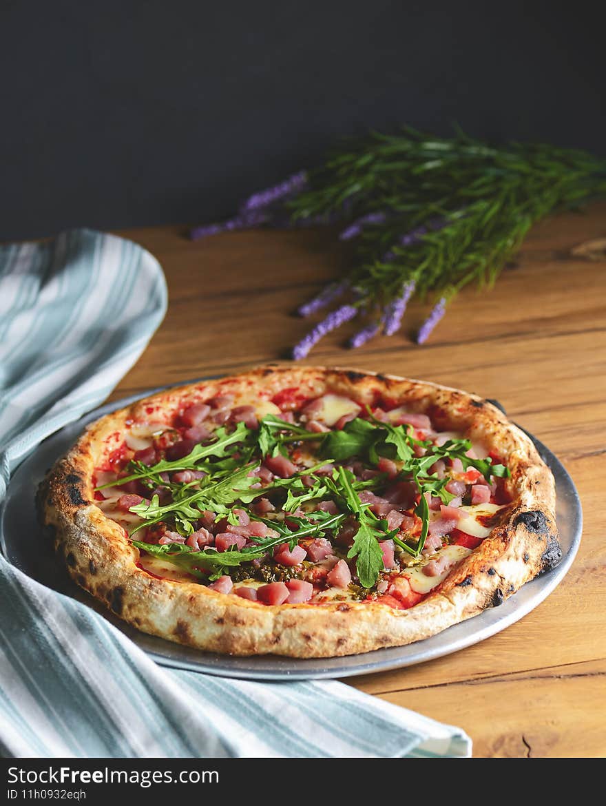 Pizza with seafood and arugula over rustic wooden background. Italian cuisine concept, Italian food, Traditional Pizza recipe
