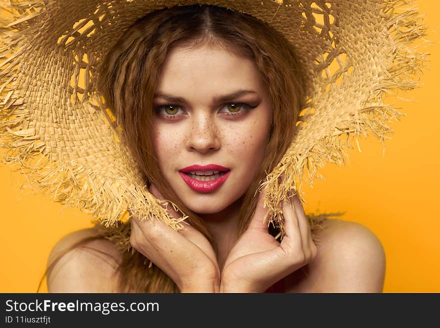 Woman in straw hat bright makeup summer lifestyle fun yellow background. High quality photo