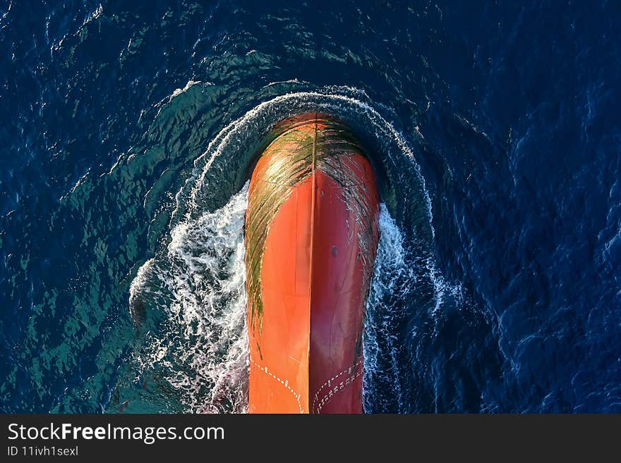 View of the big bulbous bow of cargo ship, sailing through the ocean. Paint removed by anchor chain. View of the big bulbous bow of cargo ship, sailing through the ocean. Paint removed by anchor chain.