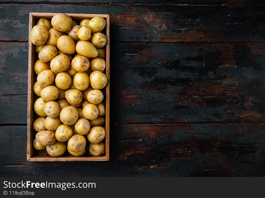Baby Potato Raw Heap, In Wooden Box, On Old Dark  Wooden Table Background, Top View Flat Lay , With Copyspace  And Space For Text