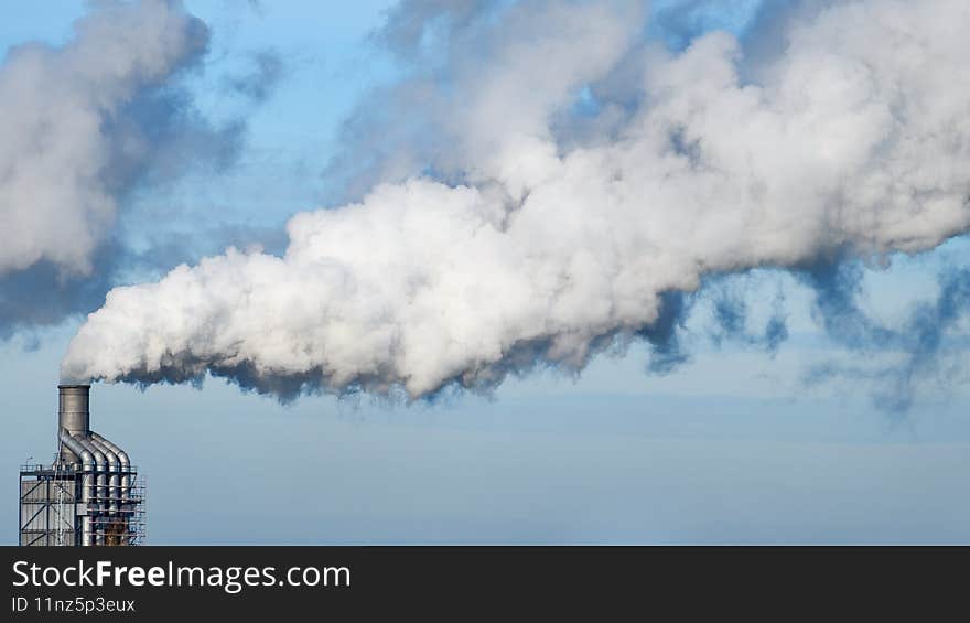 Factory chimney fumes emitting pollution to the atmosphere. co2 and greenhouse gases emissions. Factory chimney fumes emitting pollution to the atmosphere. co2 and greenhouse gases emissions