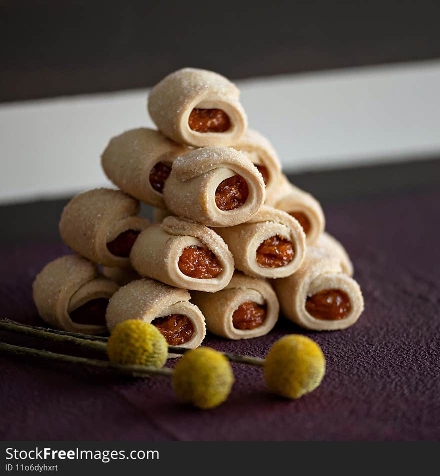 Delicious shortbread rolls with jam filling. Baking pyramid. Sweet pastries, dessert food concept. Square format or 1x1 for posting on social media.