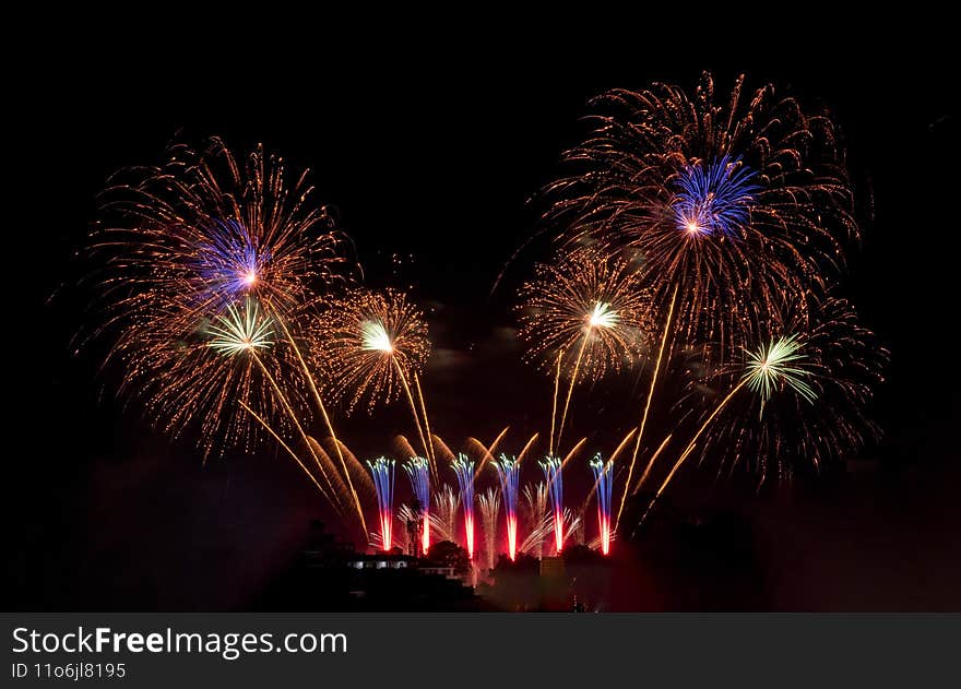 Fireworks with different color and pattern for celebration in various events including new year, party, ceremony, birthday or other show and display on night dark sky background.