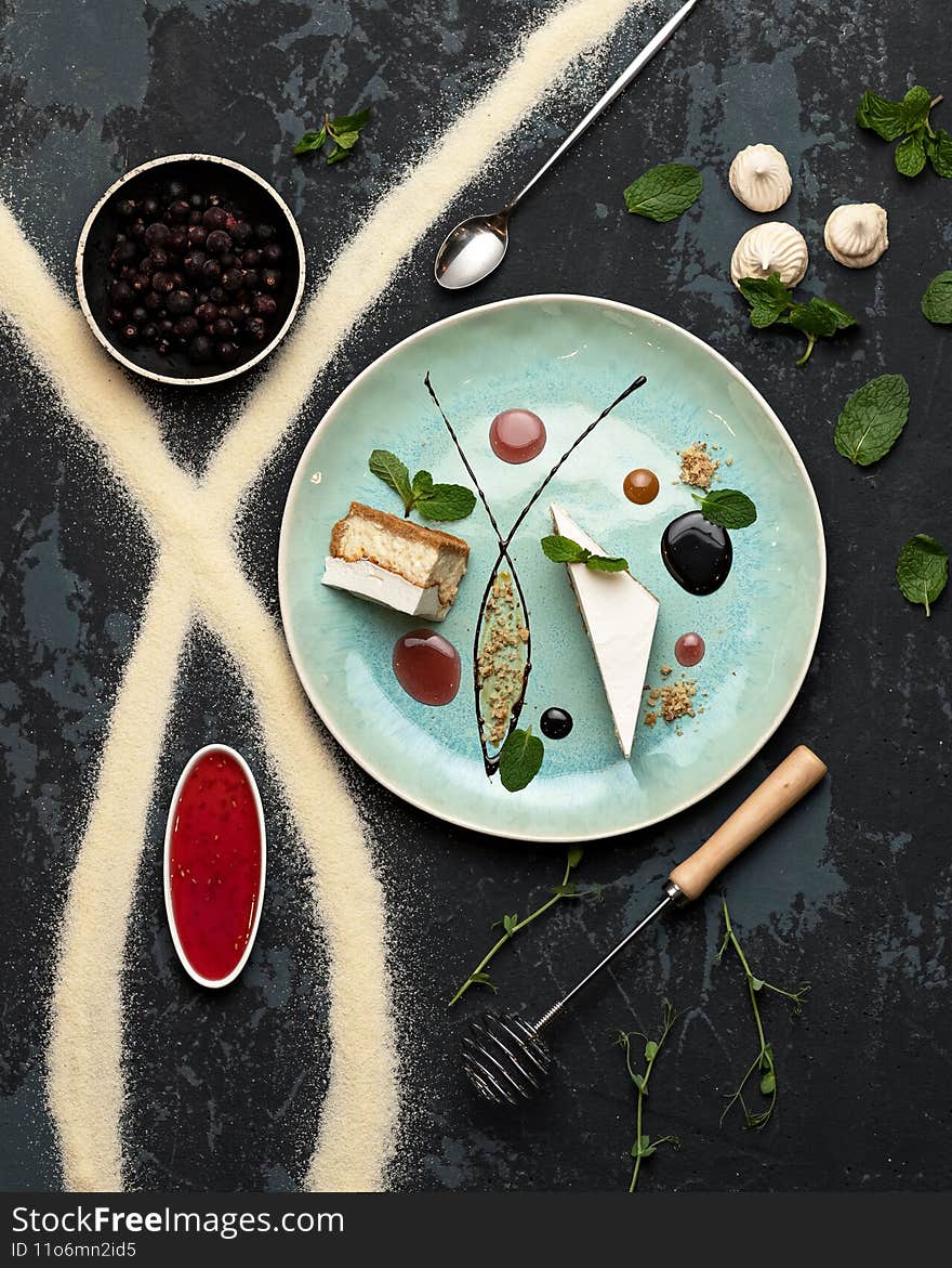 Serving of desserts. Sweet food plate in restaurant. Top view. Romantic Sweet gift or present for beloved person. Holiday or festive mood concept. Exquisite goodiesfor refined taste. Vertical format