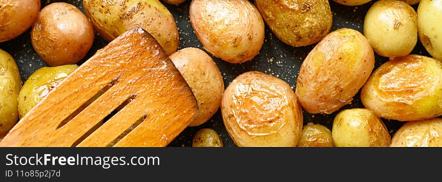 Golden roasted potatoes in the skin. banner..